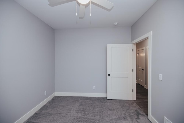 empty room featuring baseboards, a ceiling fan, carpet flooring, and visible vents