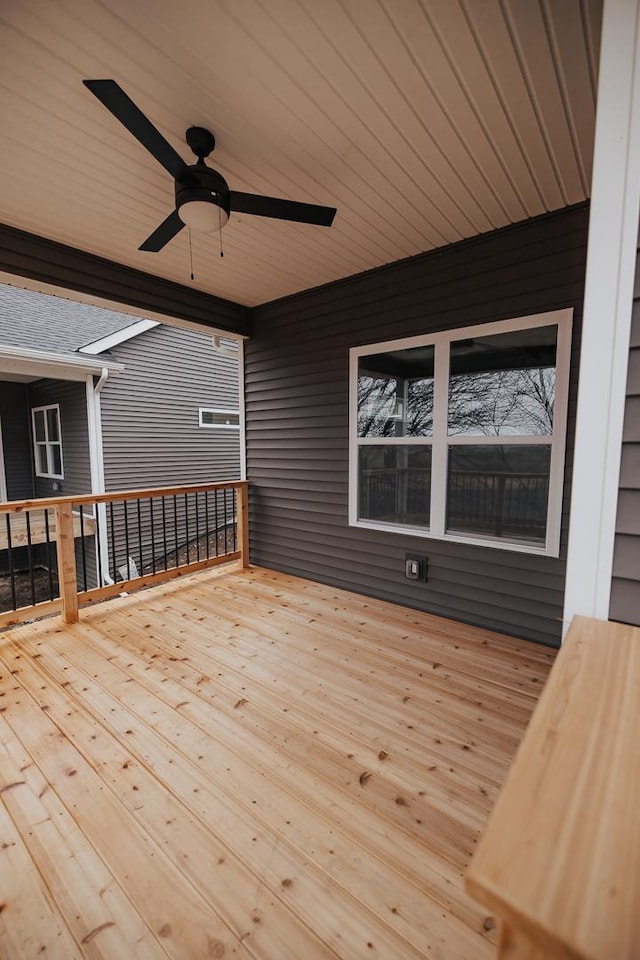 wooden deck featuring ceiling fan
