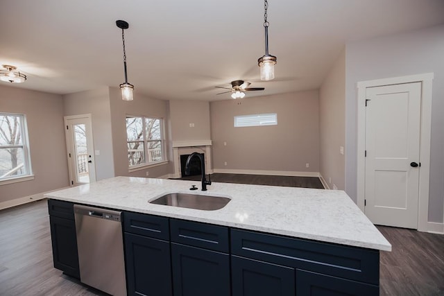 kitchen with a sink, dark wood finished floors, dishwasher, and a healthy amount of sunlight
