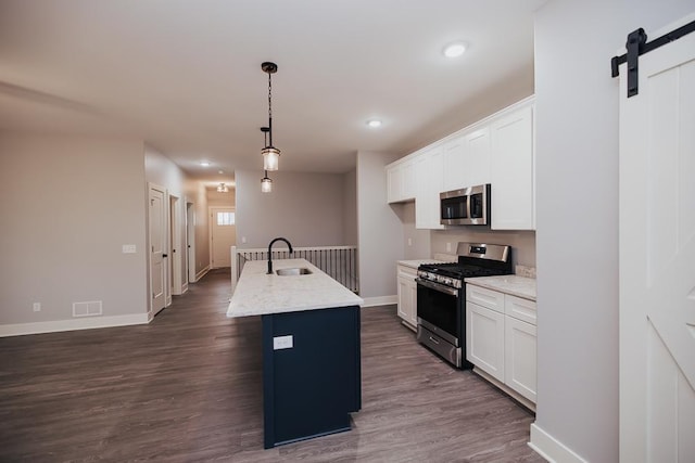 kitchen featuring visible vents, a sink, baseboards, stainless steel appliances, and dark wood-type flooring