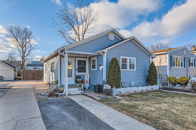 bungalow-style house with fence