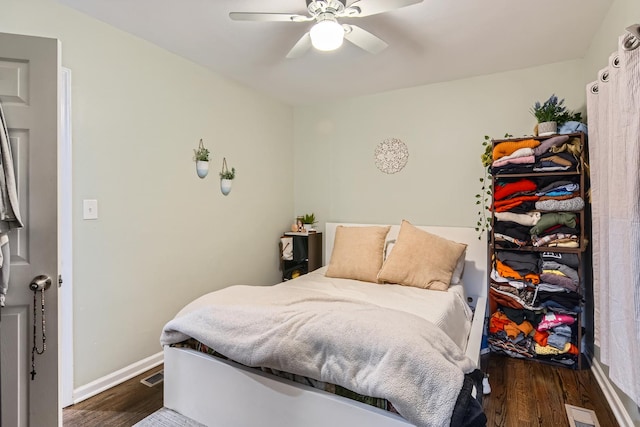 bedroom featuring baseboards, ceiling fan, wood finished floors, and visible vents