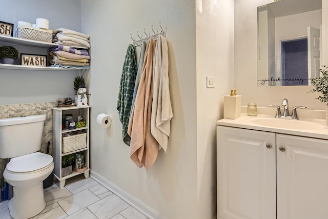 bathroom with vanity, marble finish floor, baseboards, and toilet