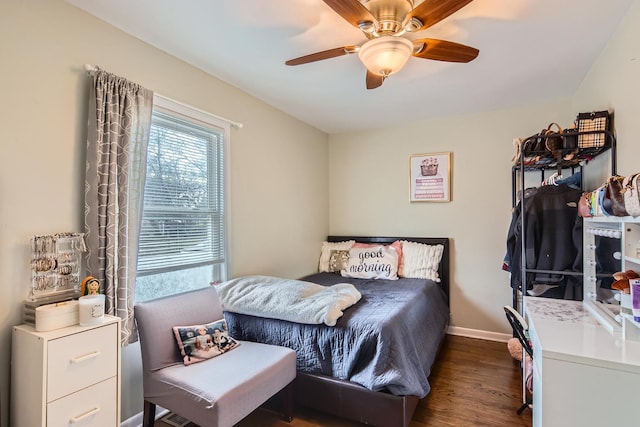 bedroom featuring a ceiling fan, baseboards, and dark wood-type flooring