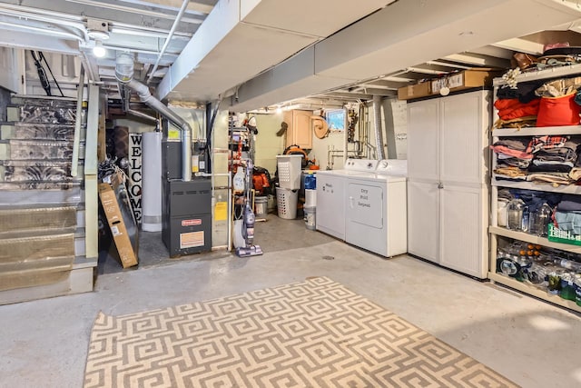 unfinished below grade area featuring heating unit and independent washer and dryer