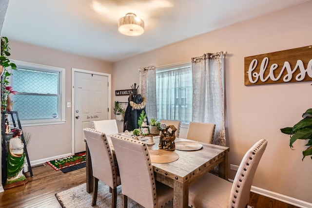 dining space featuring baseboards, visible vents, and dark wood-style floors
