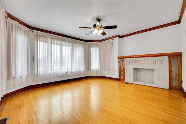 3016 N Major Ave, Chicago, IL 60634 - unfurnished living room with baseboards, ceiling fan, crown molding, hardwood / wood-style flooring, and a fireplace