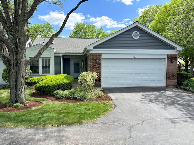 ranch-style home featuring brick siding, asphalt driveway, an attached garage, and a shingled roof
