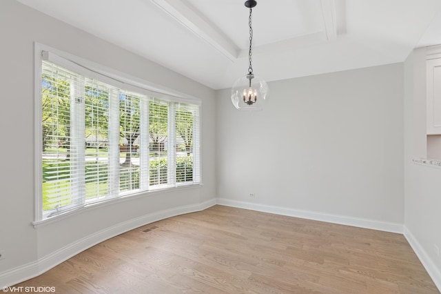 unfurnished dining area with light wood-style floors, a chandelier, a tray ceiling, and baseboards