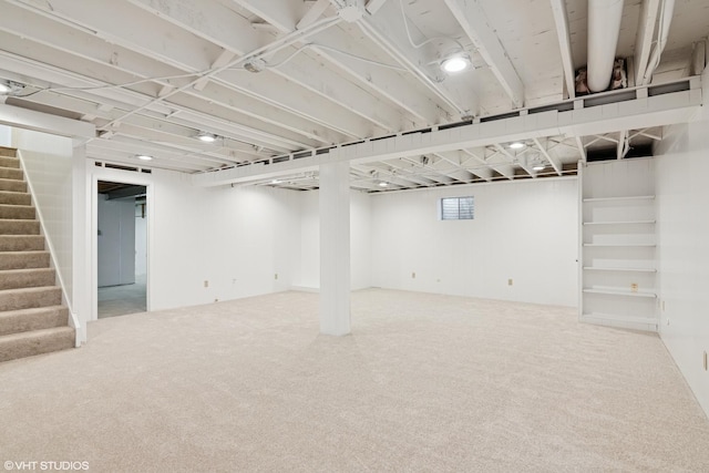 basement featuring stairway and carpet floors