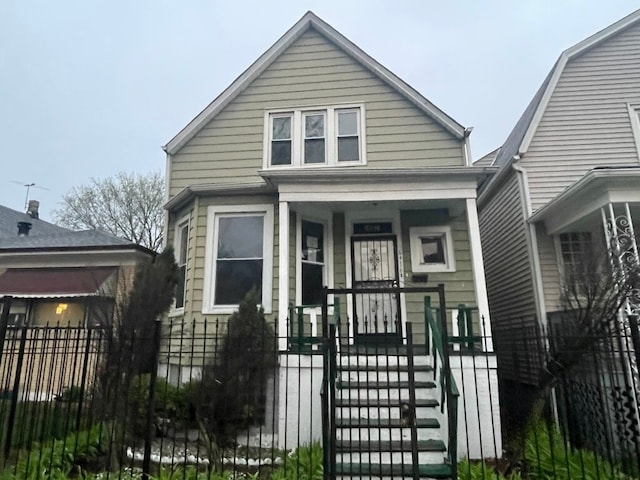 shotgun-style home with covered porch and fence private yard