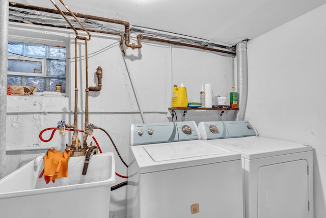 laundry room with a sink, laundry area, and independent washer and dryer