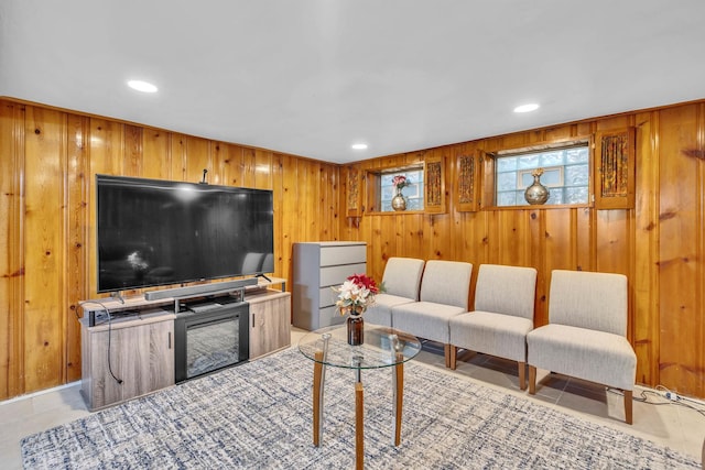 tiled living room featuring recessed lighting and wood walls