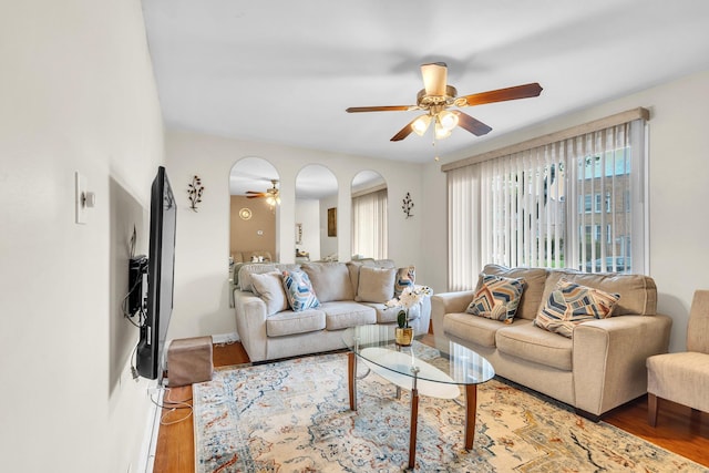living area with ceiling fan and wood finished floors