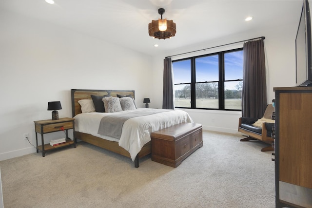 bedroom with light colored carpet, recessed lighting, and baseboards