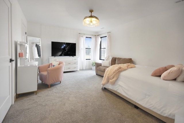 bedroom featuring carpet and a chandelier