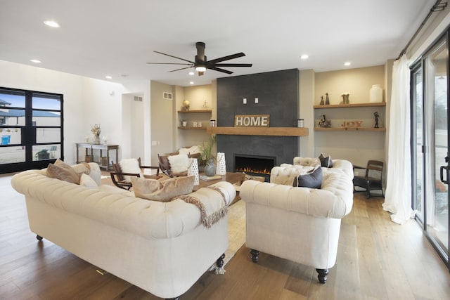 living room with plenty of natural light, a fireplace, recessed lighting, and ceiling fan