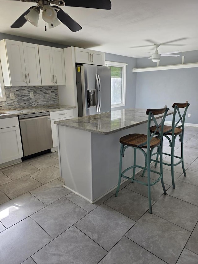 39540 N Channel View Dr, Antioch, IL 60002 - kitchen featuring stainless steel appliances, ceiling fan, backsplash, and stone counters