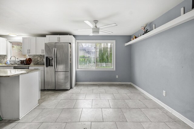 39540 N Channel View Dr, Antioch, IL 60002 - kitchen with stainless steel fridge with ice dispenser, tasteful backsplash, ceiling fan, white cabinetry, and light stone counters
