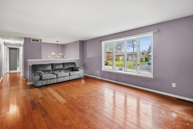 39540 N Channel View Dr, Antioch, IL 60002 - living area featuring wood-type flooring, a chandelier, and baseboards