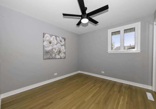 unfurnished room featuring a ceiling fan, baseboards, and wood finished floors