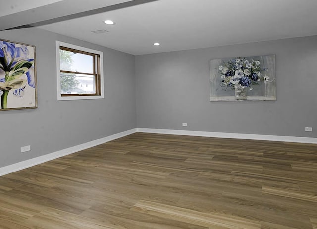 spare room featuring recessed lighting, baseboards, and wood finished floors