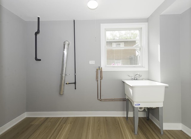 bathroom featuring baseboards and wood finished floors