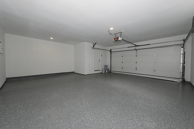garage with recessed lighting and a garage door opener