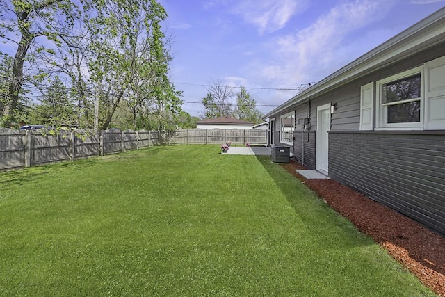 view of yard featuring a fenced backyard and central AC unit