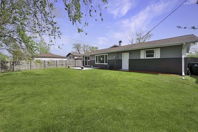 back of property with a lawn, central AC, a fenced backyard, and a patio area