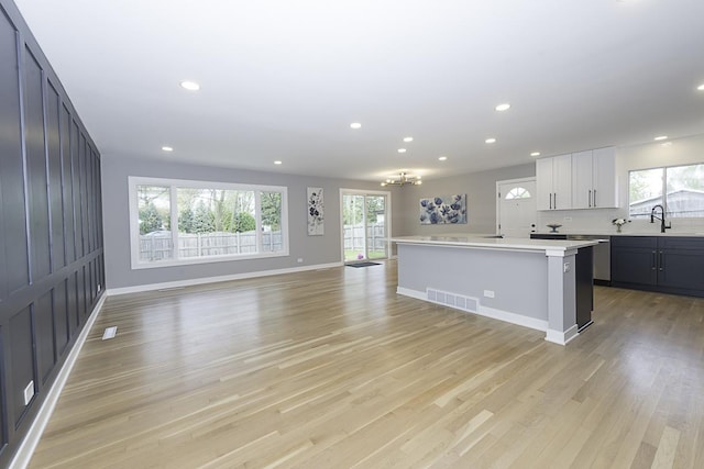 kitchen with light countertops, recessed lighting, visible vents, and light wood-type flooring