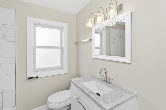 full bathroom featuring vanity, baseboards, a chandelier, and toilet