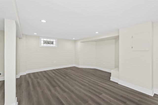 below grade area with recessed lighting, baseboards, and dark wood finished floors