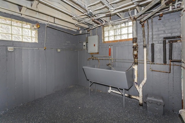 below grade area with a sink and electric panel