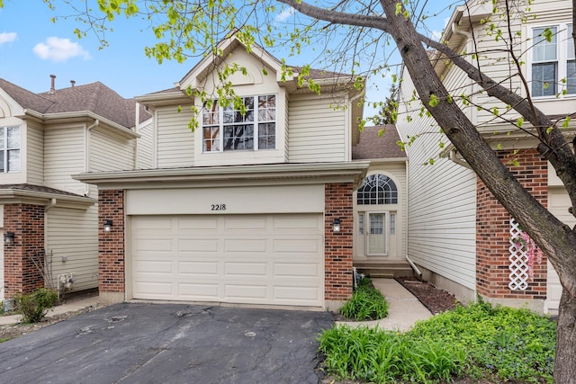 2218 Seaver Ln Unit 2218, Hoffman Estates, IL 60169 - traditional-style house with roof with shingles, brick siding, a garage, entry steps, and driveway