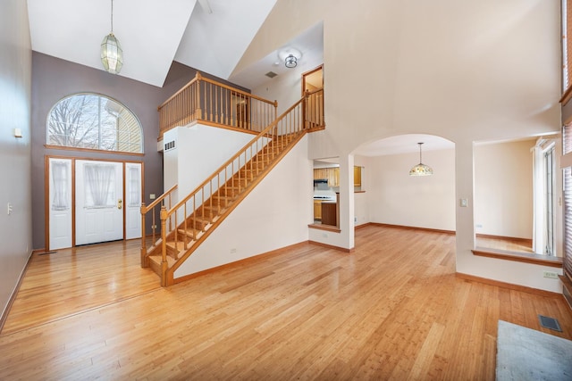 2218 Seaver Ln Unit 2218, Hoffman Estates, IL 60169 - entryway with visible vents, a towering ceiling, wood finished floors, stairway, and arched walkways