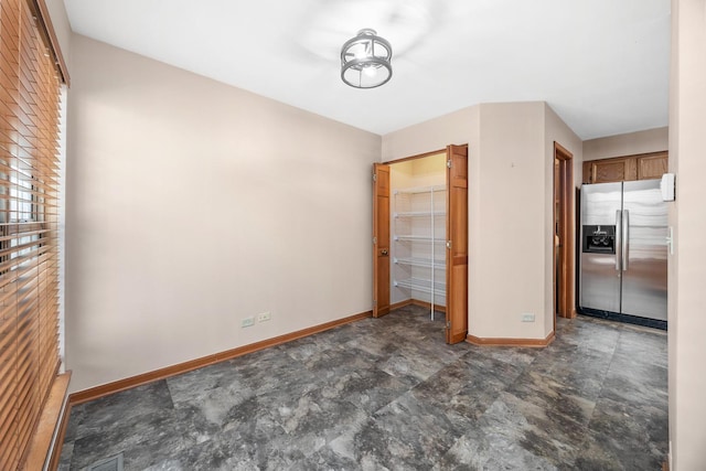 2218 Seaver Ln Unit 2218, Hoffman Estates, IL 60169 - unfurnished bedroom with baseboards, stone finish flooring, stainless steel refrigerator with ice dispenser, visible vents, and a closet