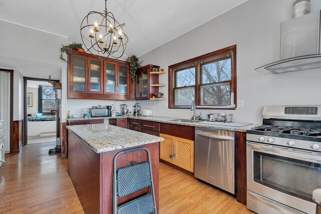 401 7th St, Mazon, IL 60444 - kitchen featuring appliances with stainless steel finishes, wall chimney exhaust hood, a sink, and light wood-style flooring