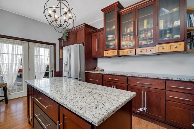 401 7th St, Mazon, IL 60444 - kitchen featuring stainless steel refrigerator with ice dispenser, a chandelier, light stone countertops, hanging light fixtures, and light wood finished floors