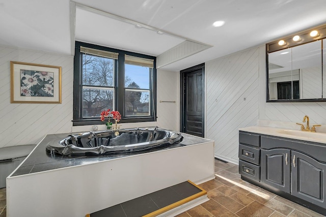 401 7th St, Mazon, IL 60444 - bathroom with wood walls, vanity, and a garden tub