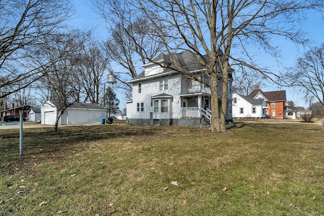 401 7th St, Mazon, IL 60444 - american foursquare style home with covered porch, a front lawn, a detached garage, and an outbuilding