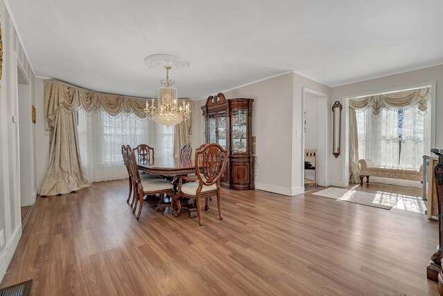 401 7th St, Mazon, IL 60444 - dining room with a chandelier, light wood-style floors, baseboards, and crown molding