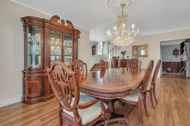 401 7th St, Mazon, IL 60444 - dining area featuring a chandelier, light wood finished floors, crown molding, stairs, and baseboards