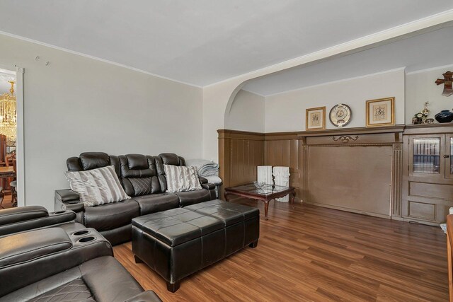 401 7th St, Mazon, IL 60444 - living room featuring wood finished floors, crown molding, and arched walkways