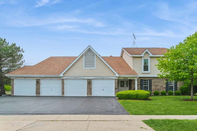305 N Creekside Trl Unit C, Mchenry, IL 60050 - traditional-style home featuring an attached garage, asphalt driveway, a front lawn, brick siding, and roof with shingles
