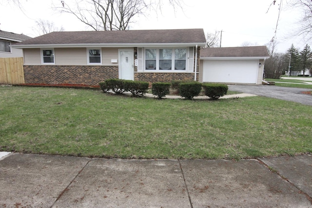 single story home featuring fence, driveway, a front lawn, and brick siding