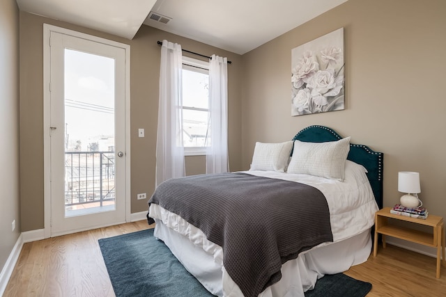 612 S Western Ave Unit 3, Chicago, IL 60612 - bedroom featuring access to outside, baseboards, visible vents, and light wood-style floors
