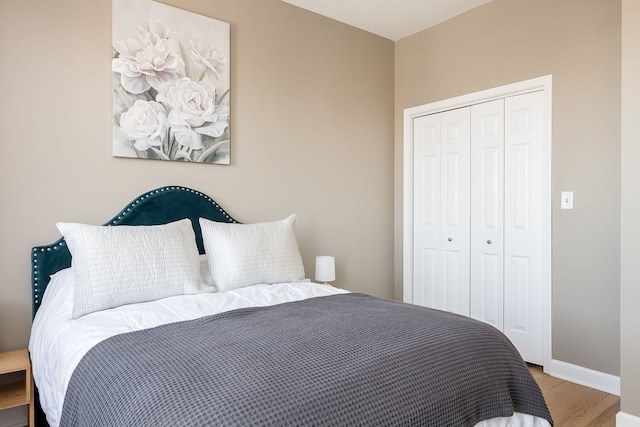 612 S Western Ave Unit 3, Chicago, IL 60612 - bedroom with baseboards, a closet, and wood finished floors