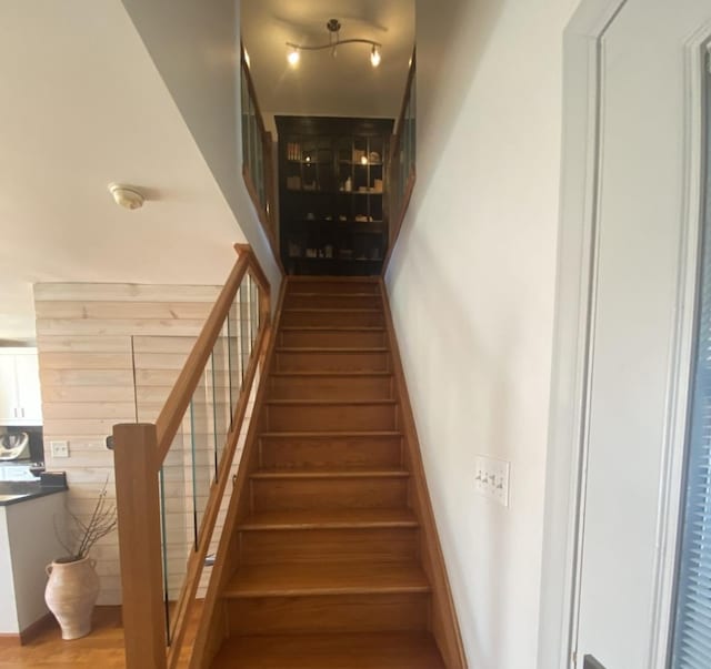 stairway featuring wood finished floors