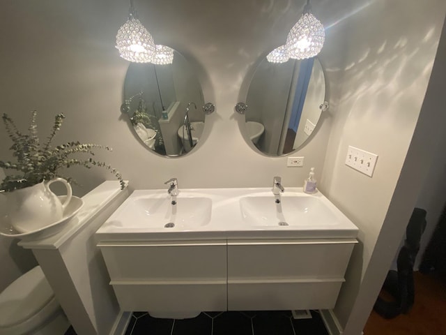 bathroom with toilet, double vanity, tile patterned flooring, and a chandelier